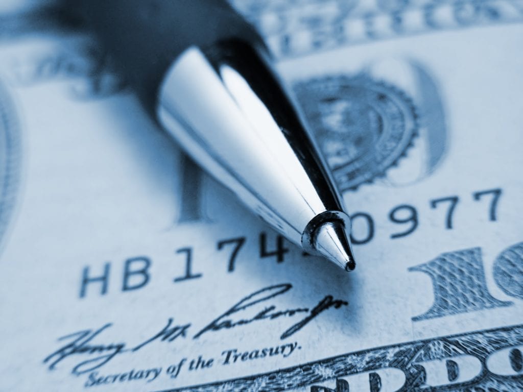 image of a 100 dollar bill close up with a pen sitting on top